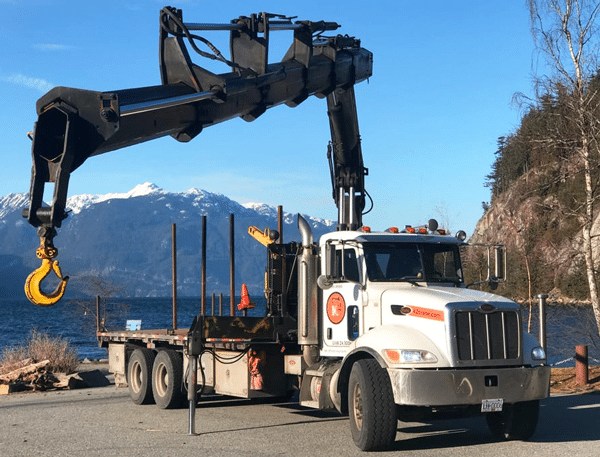 Crane truck in front of mountains
